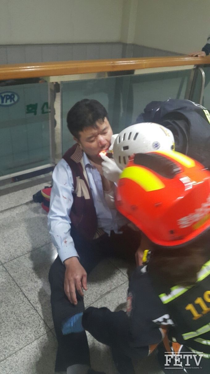유성기업 노조원들의 폭행으로 중상을 입은 노무담당 임원이 피범벅이 된 얼굴을 119 구조대가 닦아주고 있는 모습 (사진=유성기업 제공)