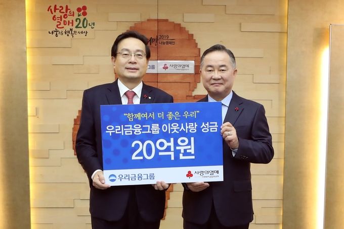 우리금융그룹은 30일 서울시 중구에 위치한 사회복지공동모금회에서 ‘이웃사랑 성금 전달식’을 가졌다. 손태승 우리금융그룹 회장(사진 왼쪽)이 예종석 사회복지공동모금회 회장과 기념 촬영을 하고 있다.
