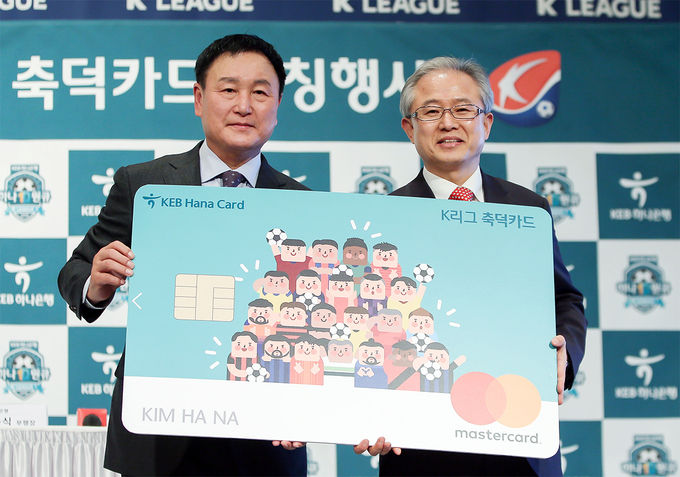 KEB하나은행은 지난 26일 2019 하나원큐 K리그 개막에 맞춰 한국프로축구연맹과 함께 'K리그 축덕카드'를 출시했다. 정춘식 KEB하나은행 개인영업그룹 부행장(사진 오른쪽)이 허정무 한국프로축구연맹 부총재와 함께 기념촬영을 하고 있다.