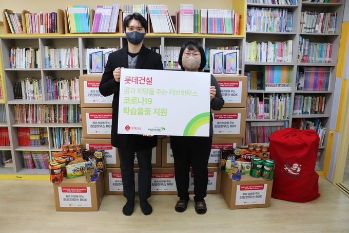 롯데건설 ESG팀 직원(왼쪽)과 꿈나래 지역아동센터 김명화 센터장(오른쪽)이 함께 기념촬영을 하고 있다. 제공=롯데건설