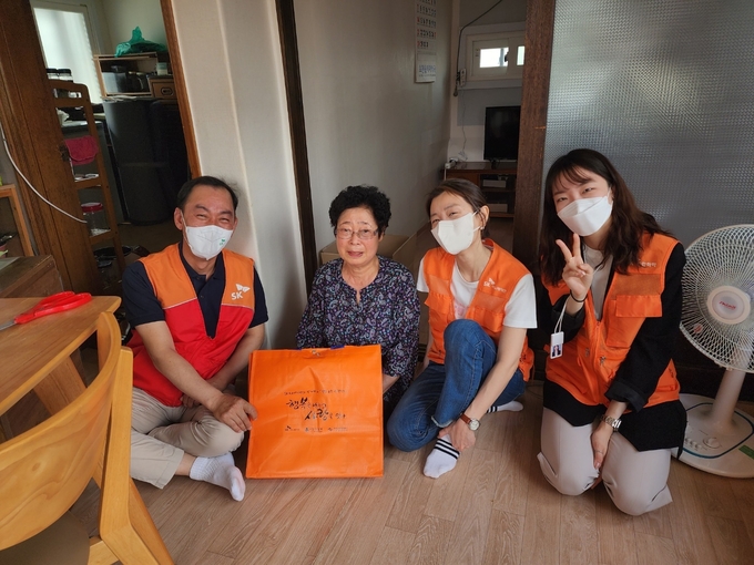지난 5월26일 ‘행복나눔 사랑잇기’ 대면 봉사활동에 참여한 SK어스온 명성 사장(왼쪽 첫 번째)과 구성원들이 홀몸 어르신 가정을 방문해 기념사진을 촬영하고 있다.(사진=SK이노베이션)