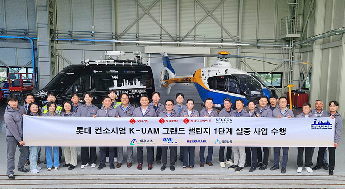 전남 고흥 항공센터에서 ‘롯데 컨소시엄’ 관계자들이 ‘K-UAM 그랜드챌린지-1단계’ 실증 사업을 성공적 마치고 기념촬영을 하고 있다.(사진=롯데건설) 