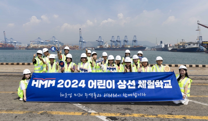  8일 부산신항에 위치한 HMM터미널(HPNT)에서 상선체험 활동에 참여한 어린이들이 기념촬영을 하고 있다.(사진=HMM)