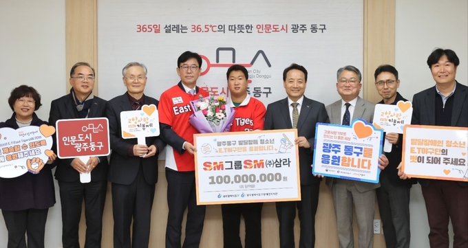 성낙원 SM상선 건설부문 대표이사(왼쪽 4번째), 서지원 E.T 야구단 선수(가운데), 임택 광주광역시 동구청장(오른쪽 4번째)이 6일 동구청에서 열린 E.T 야구단 기부금 전달식에서 동구청, 동구장애인복지관 관계자들과 기념촬영을 하고 있다.